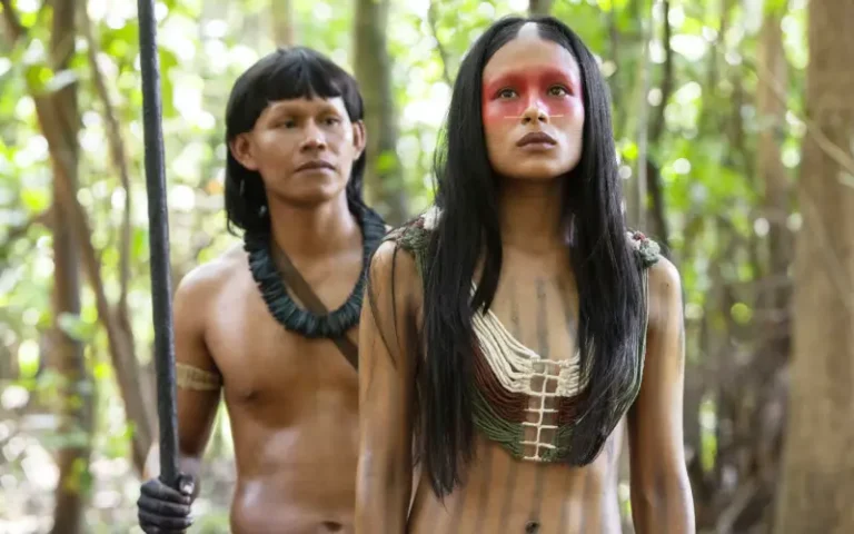 Los actores principales de 'Frontera Verde', caminando a través de la selva amazónica, en una escena que destaca la atmósfera misteriosa y natural de la serie.
