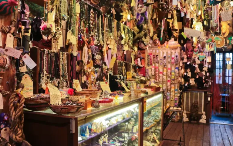 Artículos esotéricos Hoodoo exhibidos en una tienda espiritual, con velas, raíces, aceites y objetos rituales tradicionales