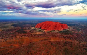 Formación rocosa Uluru al atardecer en el desierto australiano, lugar sagrado para los pueblos aborígenes Anangu